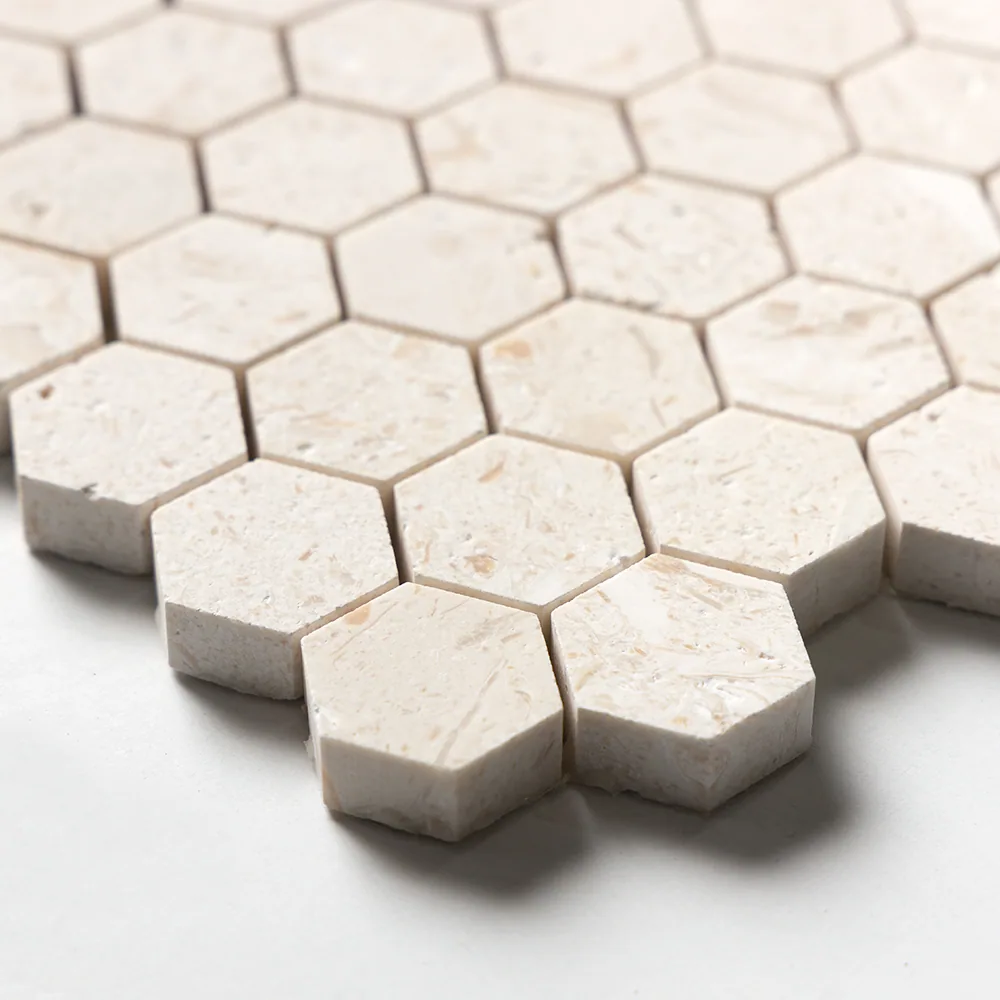Close view of the limestone hexagons, showing the brushed matt faces, the fine pitting and the crisp cut edges between them.
