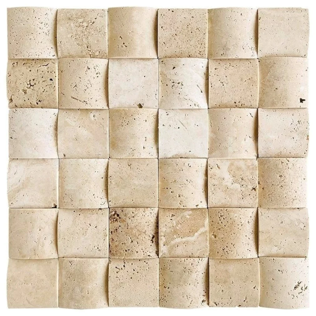 Ivory travertine mosaic of two-inch squares with curved, pillowed faces, so the sheet reads as a softly undulating surface in warm cream.