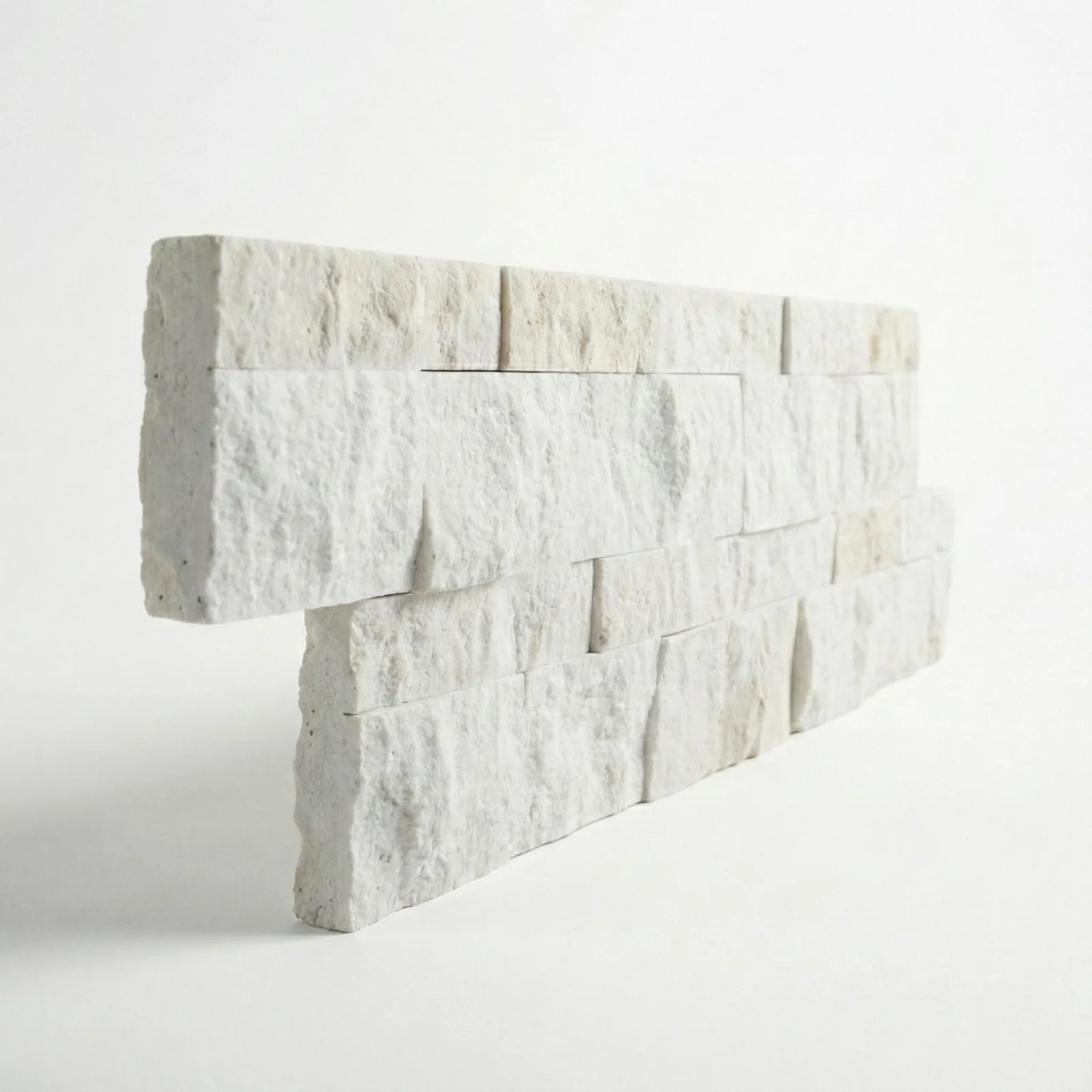 A limestone ledger panel corner piece on a studio ground, the returned end showing the panel's depth.