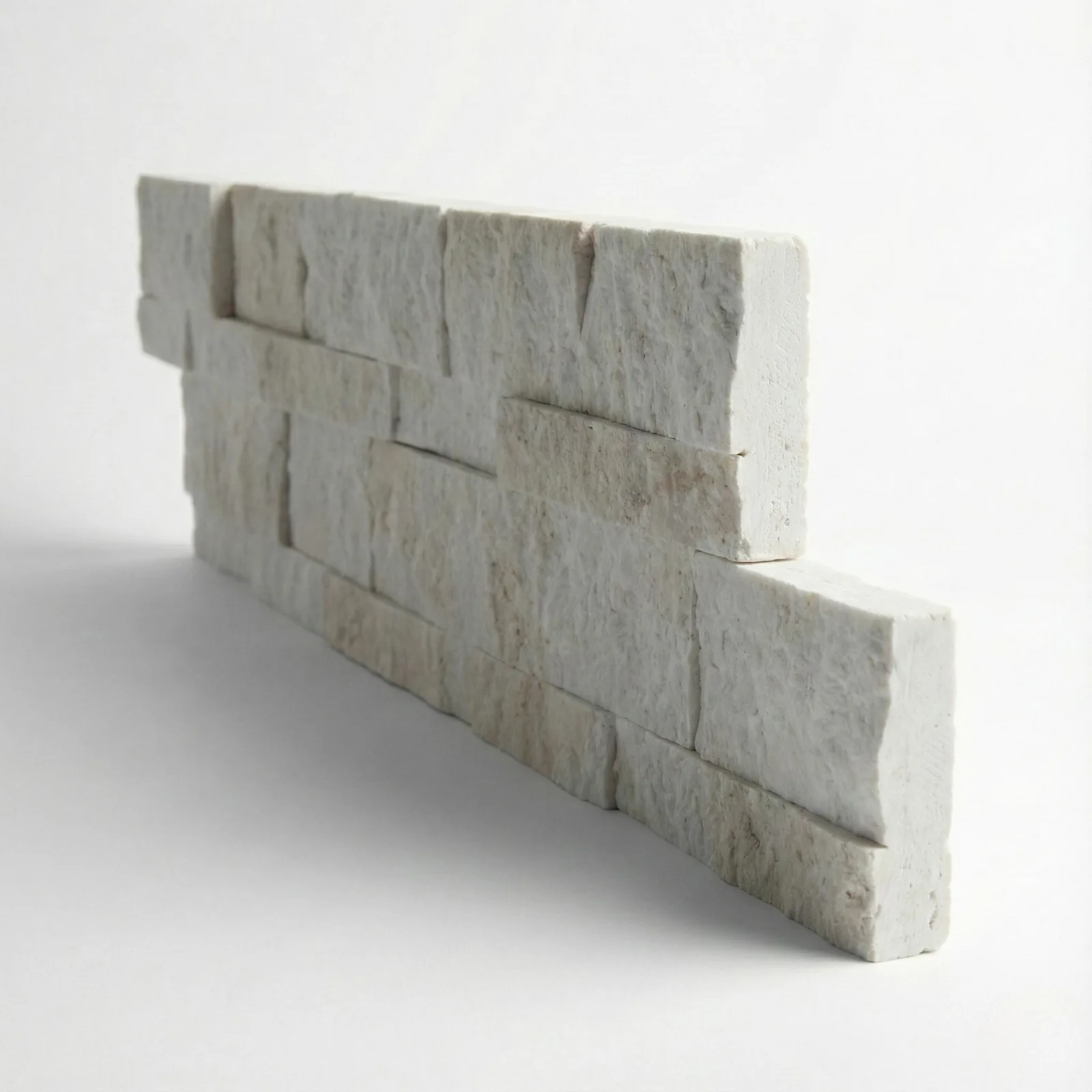 A Myra Beige marble ledger panel corner piece on a studio ground, the returned end showing the panel's depth.