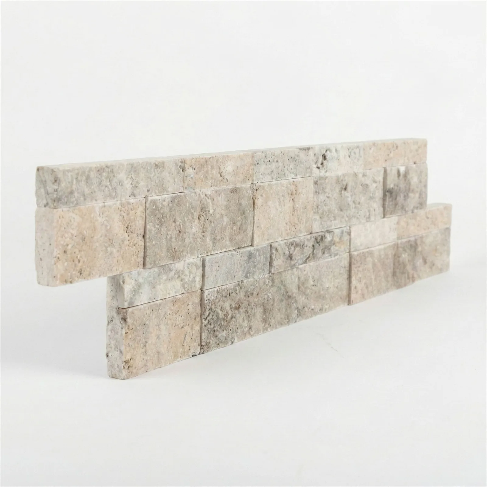 Silver travertine ledger panel corner piece on a pale studio ground: split-face strips in warm grey and taupe across two offset courses.